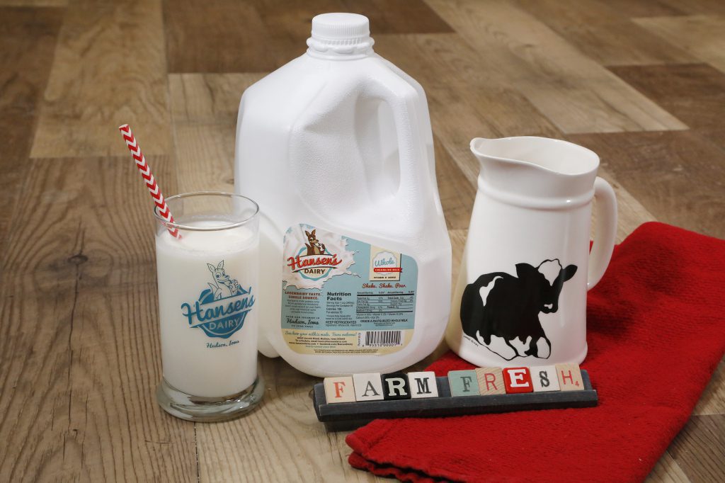 Hansen's gallon of milk alongside a glass of milk